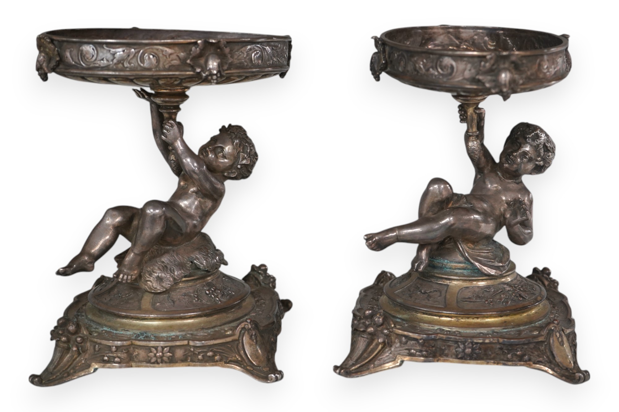 A pair of Victorian Elkington & Co. silver plated ‘putti’ stands, 17cm. Condition - fair to good